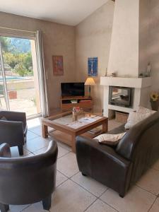 a living room with a couch and a coffee table at Le Mas des Genets in Saint-Rémy-de-Provence