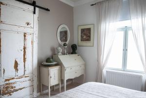 a bedroom with a bed and a dresser and a window at Kerttula in Skinnarby