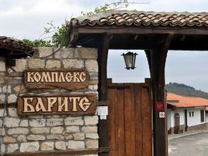 a stone building with a street sign and a door at Complex Barite in Chernevo
