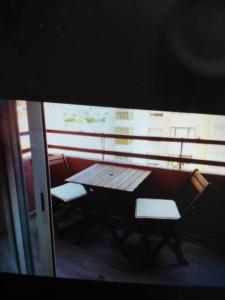 a table and two chairs sitting on a balcony at San juan de Alicante 450 € la Semana in San Juan de Alicante