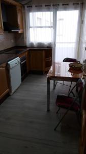 a kitchen with a table and a table and a table and chairs at San juan de Alicante 450 € la Semana in San Juan de Alicante