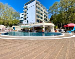 a large building with a swimming pool in front of a building at BSA Holiday Park Hotel - All Inclusive in Golden Sands