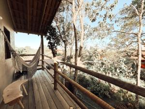 a hammock on the porch of a tree house at CASA MUNDI in Caraíva