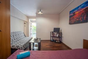 a living room with a couch and a table at James Room in Samos