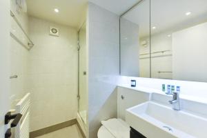 a bathroom with a sink and a mirror at London Choice Apartments - Covent Garden - Leicester Square in London