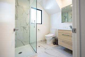 a bathroom with a shower and a toilet at Stylish home in Christchurch central in Christchurch