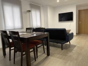 a dining room with a table and chairs and a television at Apartamento Suite Córdoba in Córdoba