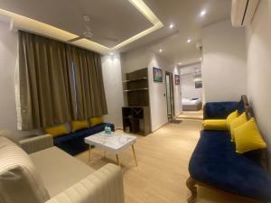 a living room with a couch and a table at Hotel Azul Ganga in Rishīkesh