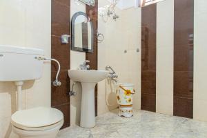 a bathroom with a toilet and a sink at Master room pvt garden by Vanasthali in Kasauli +24 photos