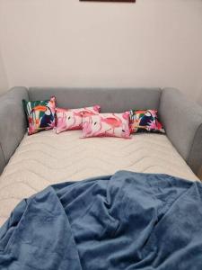 a bed with two pillows on top of it at Little Monica Apartment- Spacious, Affordable & Central in Perth