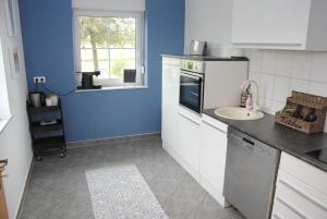 a kitchen with a sink and a counter top at Ferienwohnung Hof Konietzke in Thale +6 photos