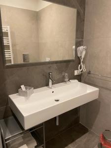 a bathroom with a white sink and a mirror at Maqueda Suites in Palermo