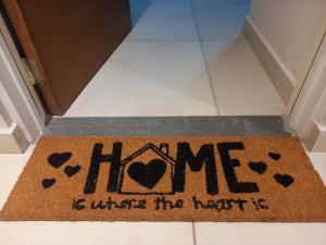 a welcome mat with the words home is where the house is at Opalo Barrio Sur A Estrenar by Citrino Aparts in San Miguel de Tucumán
