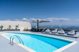 a swimming pool on the roof of a building at Abrazo Villas in Imerovigli