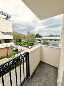 a balcony with a view of a parking lot at Apartman Rojal Vranje in Vranje