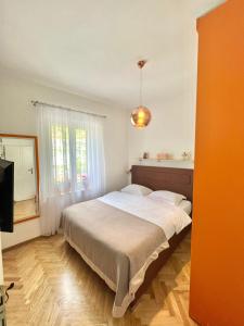 a bedroom with a large bed and a window at Apartment Kiki in Kotor