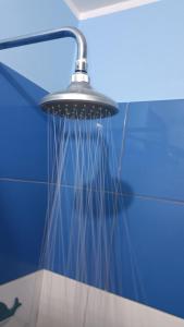 a shower with long strands of water hanging from it at Renacer apartamentos in Tacna