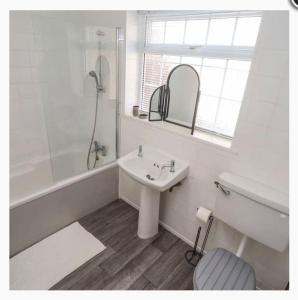 a bathroom with a sink and a shower and a toilet at CoastGuard Cottage 3 Bed House Pet Friendly, Close to Spurn Contractors Welcome in Hull