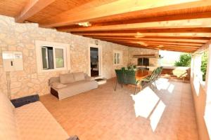 a patio with a couch and a table and chairs at Kovacic Villa with pool, tennis cart and free parking in Hrvace