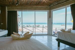 a bedroom with two beds and a view of the beach at Haadrin Resort in Haad Rin