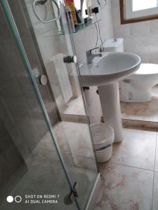 a bathroom with a shower and a sink and a toilet at Hostal Fisterra in Lugo