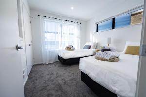 a bedroom with two beds and a window at Stylish home in Christchurch central in Christchurch