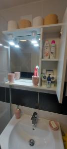 a bathroom counter with a sink and a mirror at Apartament Blaj in Blaj +10 photos