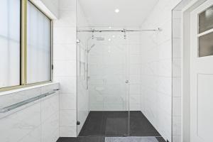 bagno con doccia e porta in vetro di Burwood City Newly renovated 2 Bed 2 Bath Free Private Parking Big Apt a Sydney
