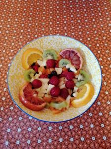 a plate of fruit on a table at La Campagne en Ville in Laragne +13 photos