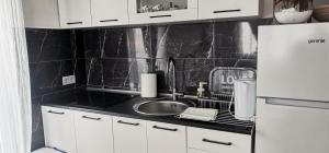 a kitchen with a sink and a white refrigerator at Sweet Dreams RD in Travnik