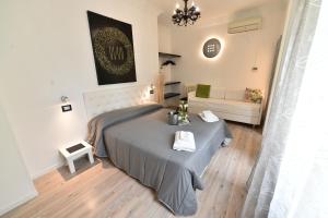 a bedroom with a bed and a couch at Hotel Okinawa in Rimini