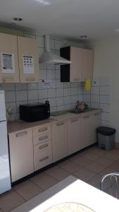 a kitchen with white cabinets and a counter top at Wille Amber in Mielno