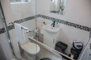 a bathroom with a toilet and a sink at Roma Guesthouse in the Heart of Lusaka in Lusaka +14 photos