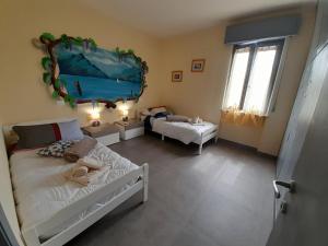 a bedroom with a bed and a room with a table at Villa La Magnolia - Private Beach Access, Garden, Views in Lazise