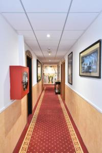 a corridor in a hospital with a red carpet at Hotel Okinawa in Rimini