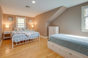 a bedroom with two beds in a attic at 1 Mi to Beach Spacious Retreat in East Sandwich! in East Sandwich