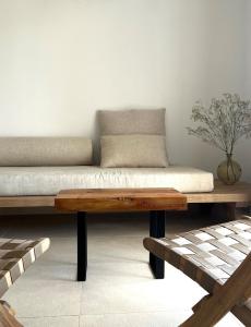 a couch sitting on a wooden bench in a room at Serena Sol in Cala Serena