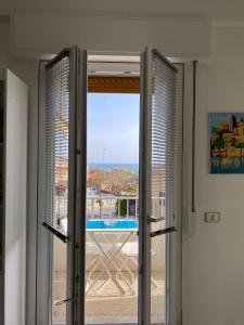a sliding glass door with a view of a balcony at Vista Azzurra in Marina di Modica