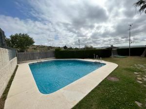a swimming pool in a yard next to a fence at Chalet con Impresionantes vistas en Conil in Conil de la Frontera