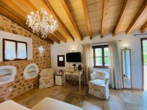 a bathroom with two urinals and a table and chairs at Finca Cas Sant in Sóller