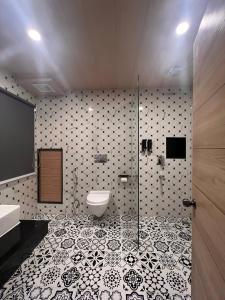 La salle de bains est pourvue de toilettes et d'une douche en verre. dans l'établissement Avianna Gangtok Resort & Spa, à Bhurtuk