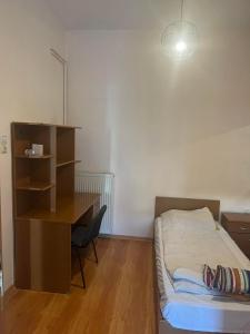 a bedroom with a desk and a bed and a desk and a bed gmaxwell gmaxwell at Two bedroom apartment in Historical area in Thessaloniki