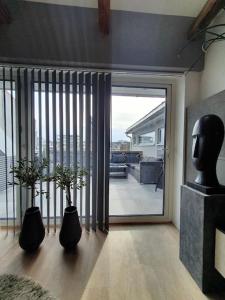 a living room with a large sliding glass door at Modern loftsleilighet in Fredrikstad