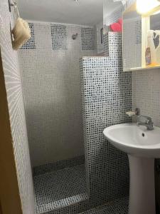 a bathroom with a shower and a sink at Two bedroom apartment in Historical area in Thessaloniki