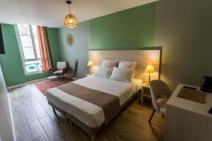a bedroom with a large bed with green walls at HOTEL restaurant CÔTE GARONNE le BALCON DES DAMES - Tonneins Marmande Agen - chambres climatisées in Tonneins