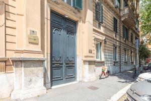 a building with a large blue door on the side of it at Spanish Steps Hills Apartment -TopCollection in Rome