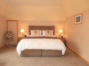 a bedroom with a large bed with white sheets and pillows at The Willows - Room Only Accommodation in Fort William