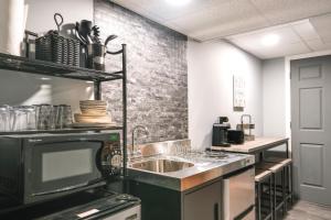 a kitchen with a sink and a microwave at Quaint Forest Heights Escape about 9 Mi to Downtown DC 