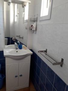 a bathroom with a white sink and a mirror at Banyuls La Grande Bleue : studio T1 in Banyuls-sur-Mer