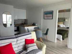 salon z kanapą i kuchnią w obiekcie Appt T2 vue imprenable sur Mer w mieście Saint-Quay-Portrieux